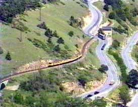 The lottle yellow train climbing in the mountains